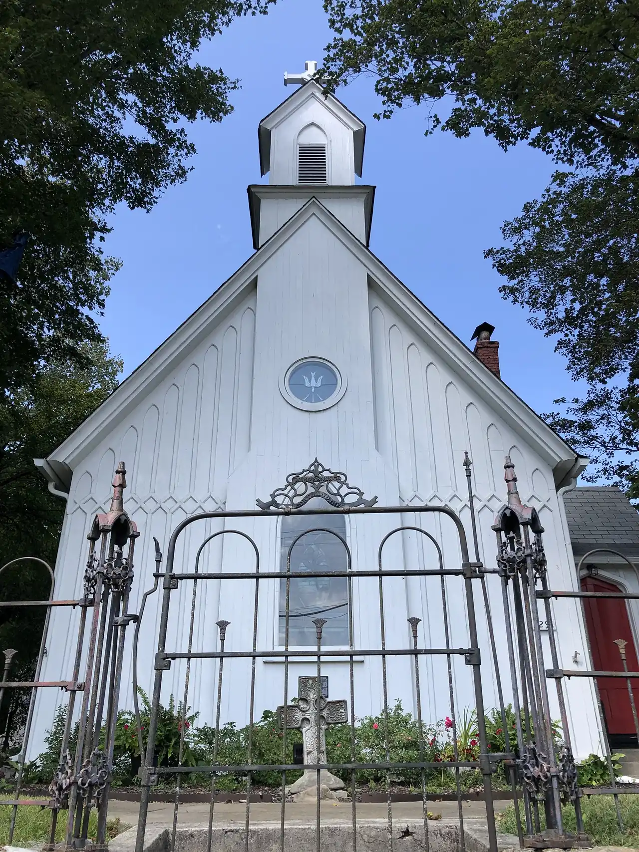 The iron gate and white board-and-batten front of Grace Episcopal Church on Main Street in Spring Hill