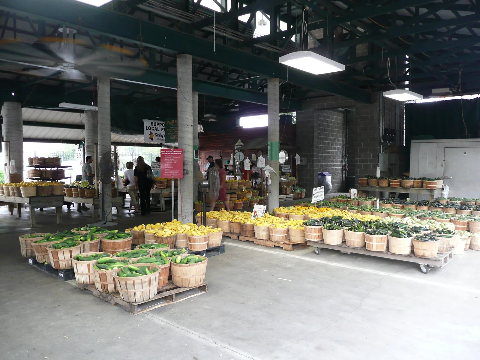 Baskets of squash and cucumbers under the shed at the Nashville Farmers' Market