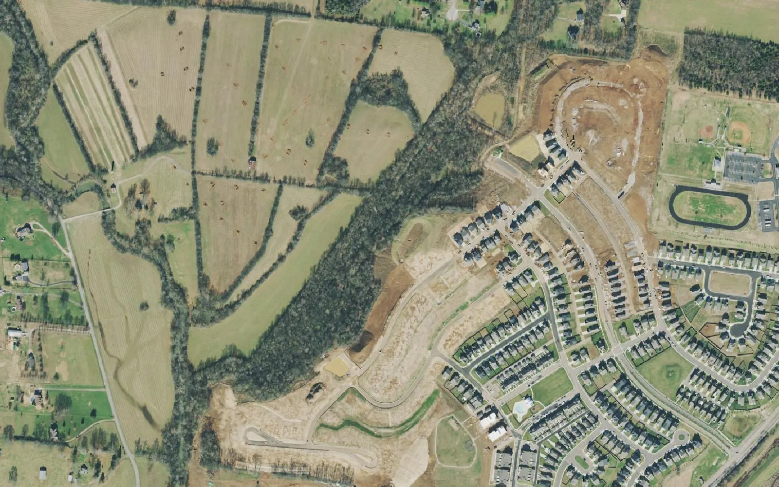 Harvest Point homes under construction beside the ball fields of Spring Hill Middle School on Spring Hill's west side, in a 2021 aerial photograph.