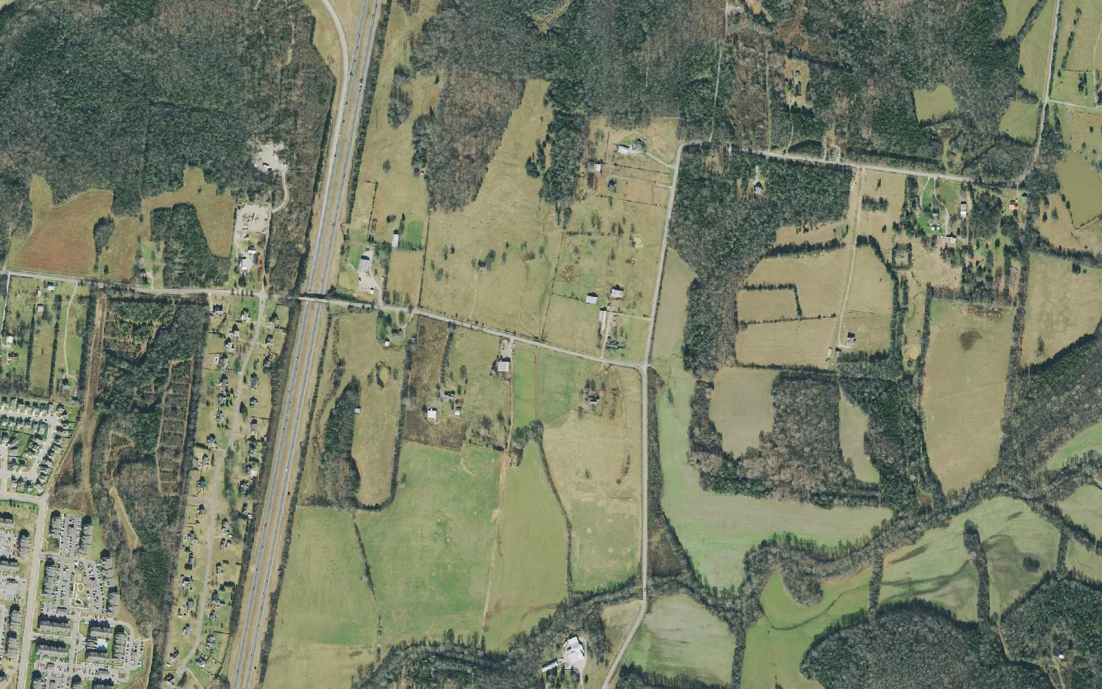 Farmland and woods east of I-65 along Jim Warren Road, Spring Hill, from the air. The picture does not show the site as it is today.