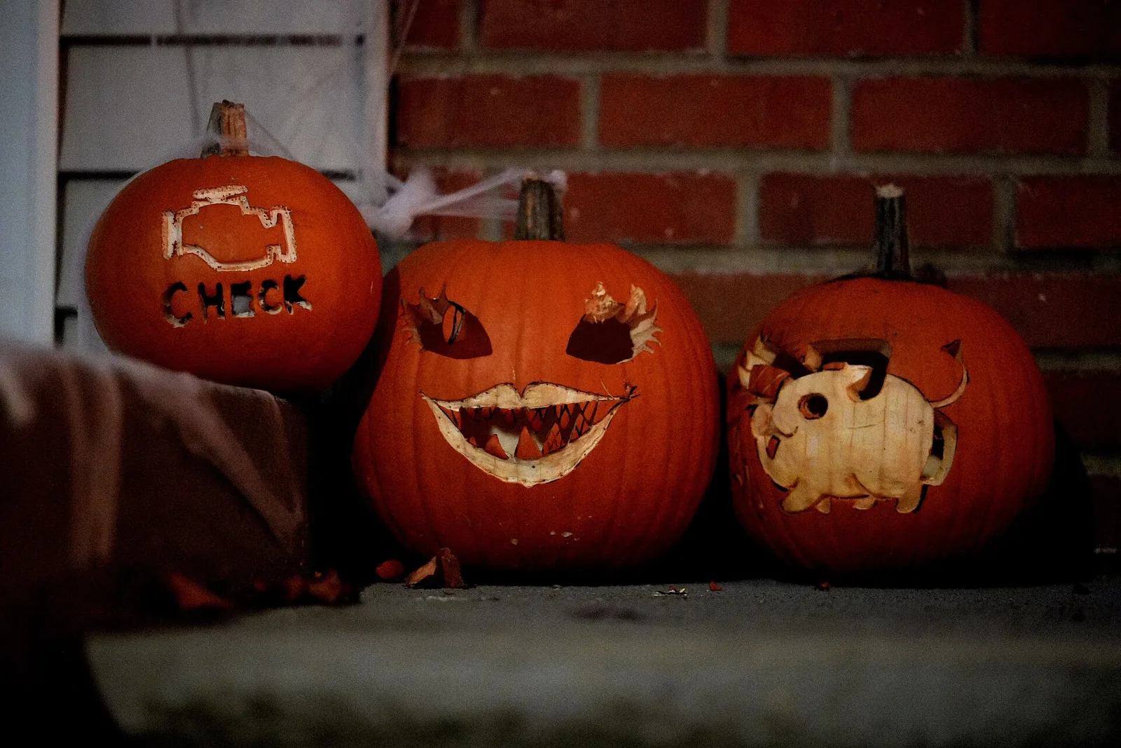 Three carved jack-o'-lanterns on a front step in Seattle
