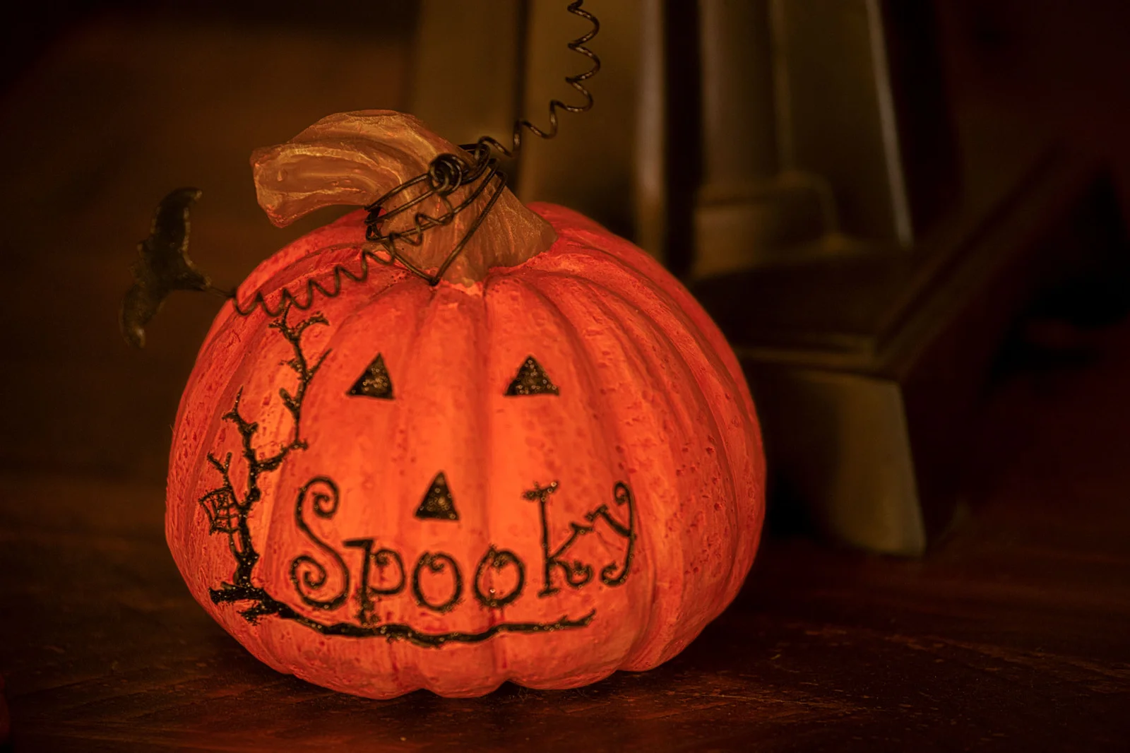 A glowing pumpkin decoration with a jack-o'-lantern face and the word Spooky