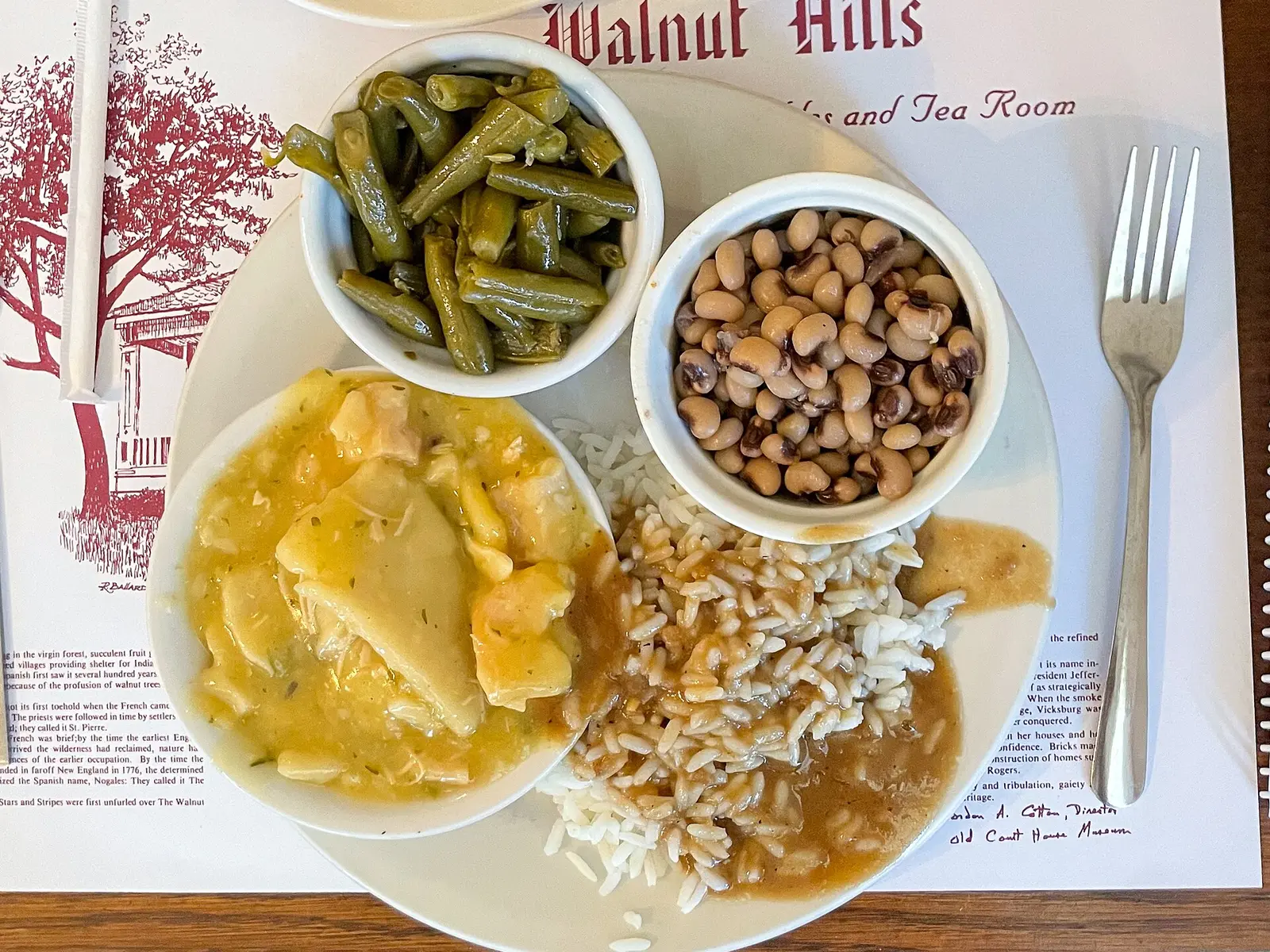 A meat-and-three plate of green beans, black-eyed peas, squash and rice with gravy at Walnut Hills restaurant.